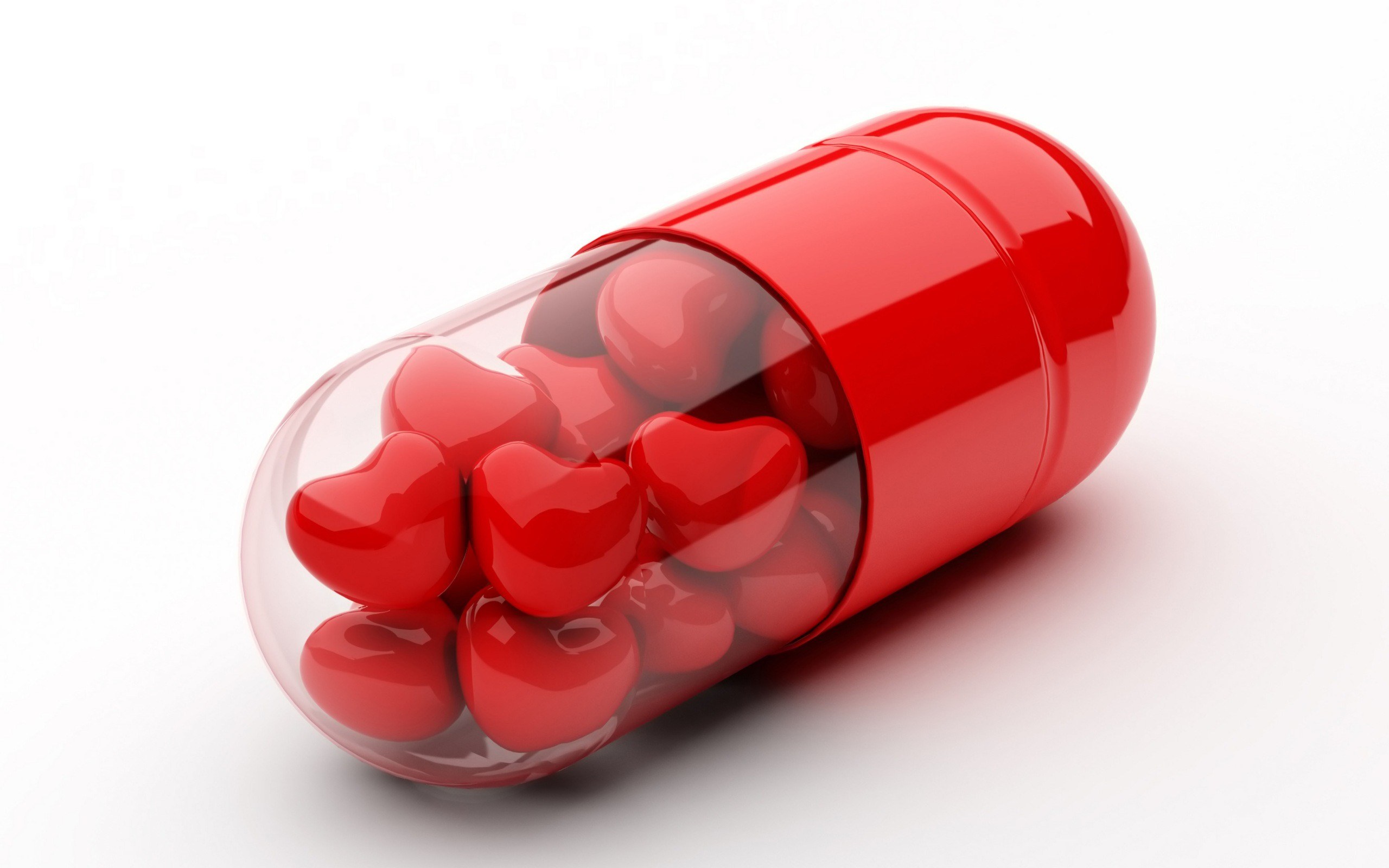 Red capsule with heart-shaped pills