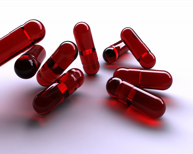 Red Capsules on White Surface — Clinical