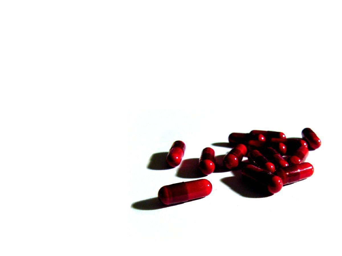 red capsules on white surface
