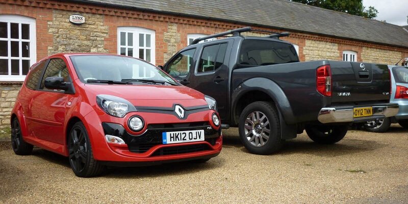 Red car and black pickup truck