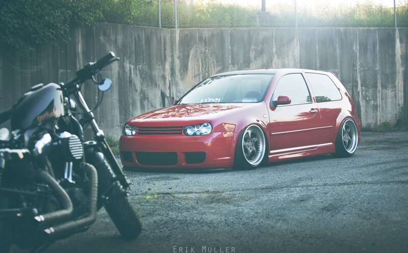 Red car and motorcycle in alley