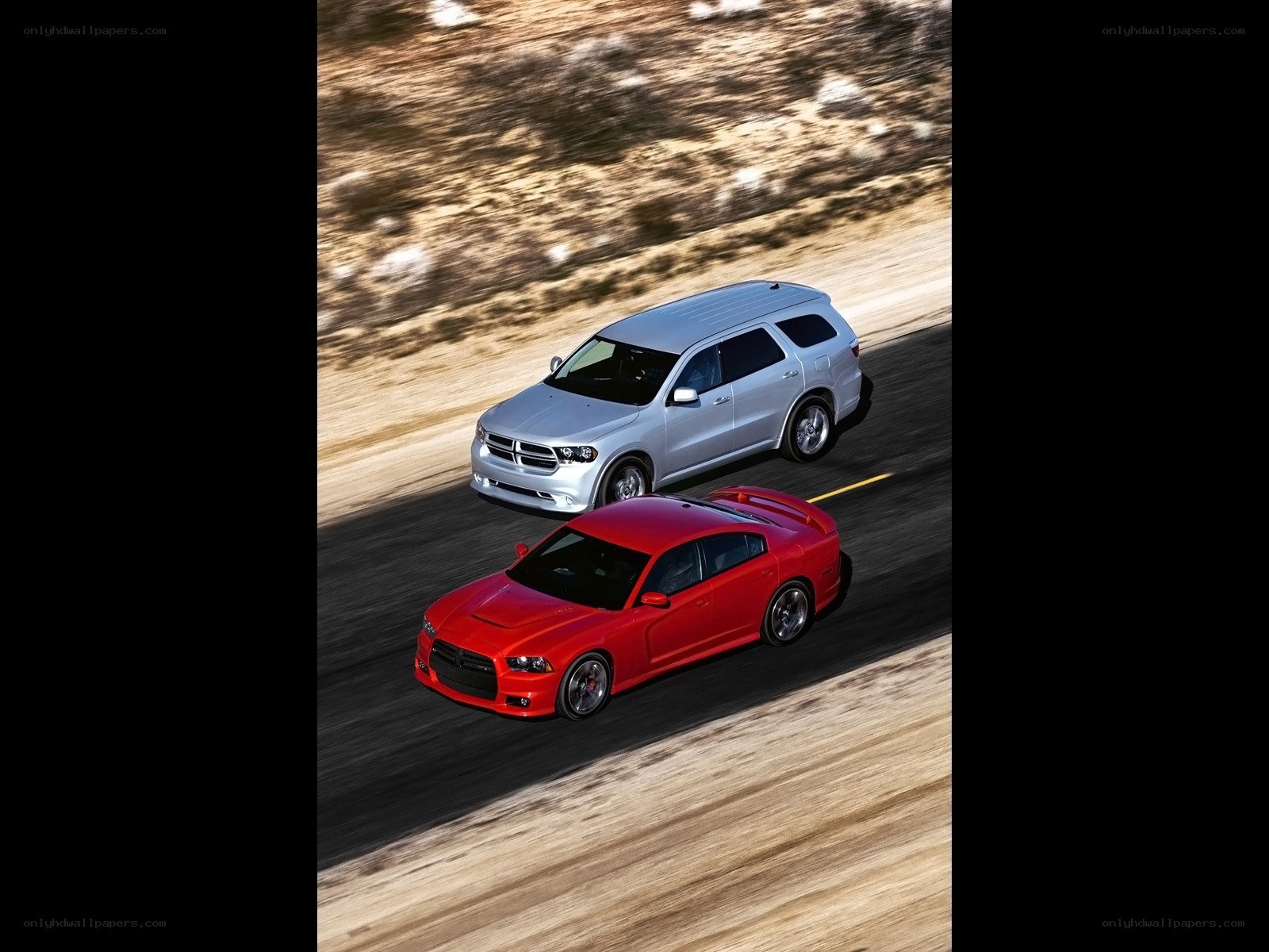 Red car and silver SUV on road