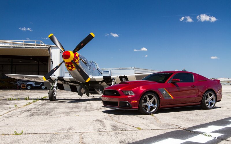 Red car and vintage plane