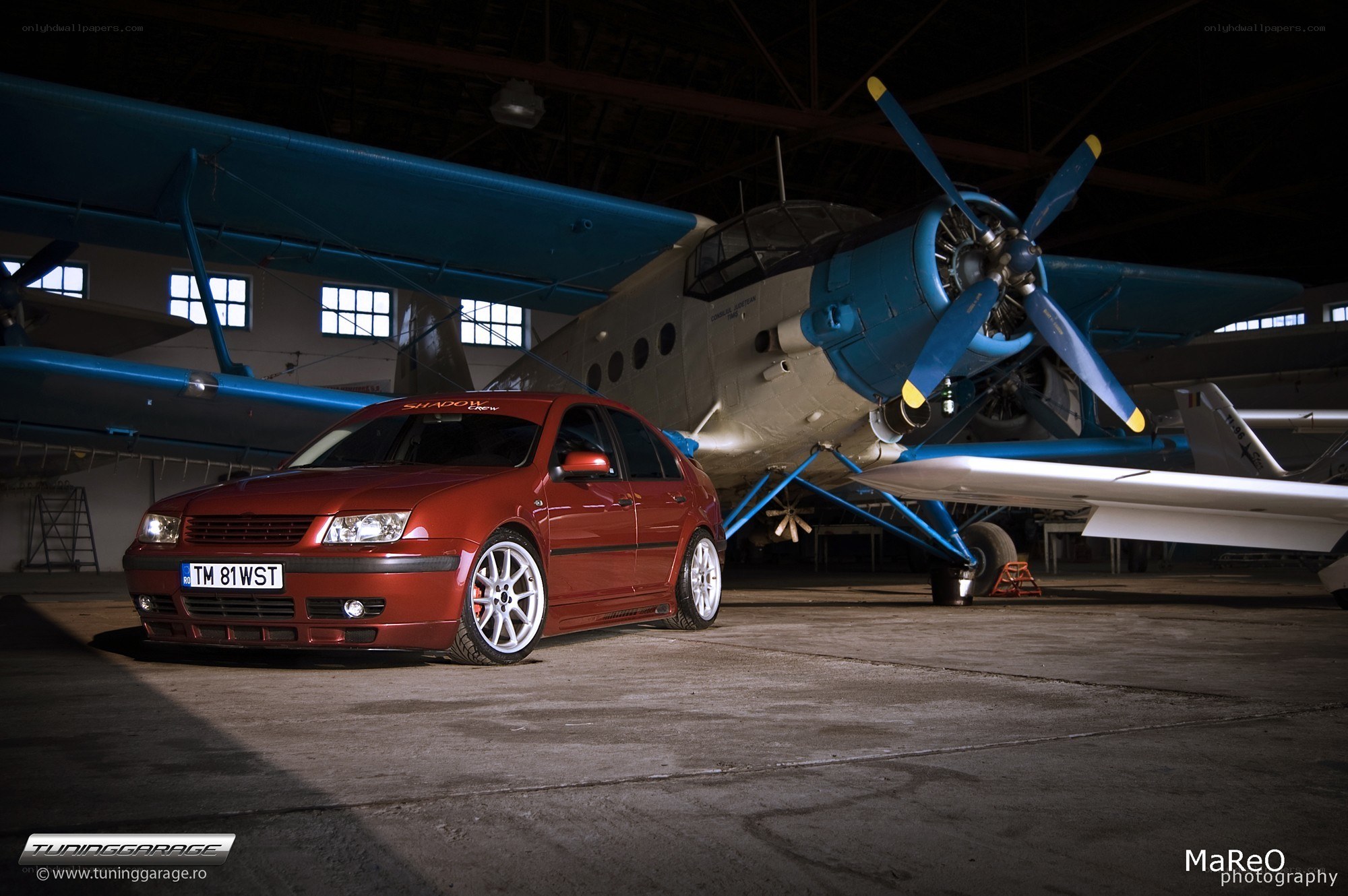 Red car and vintage plane