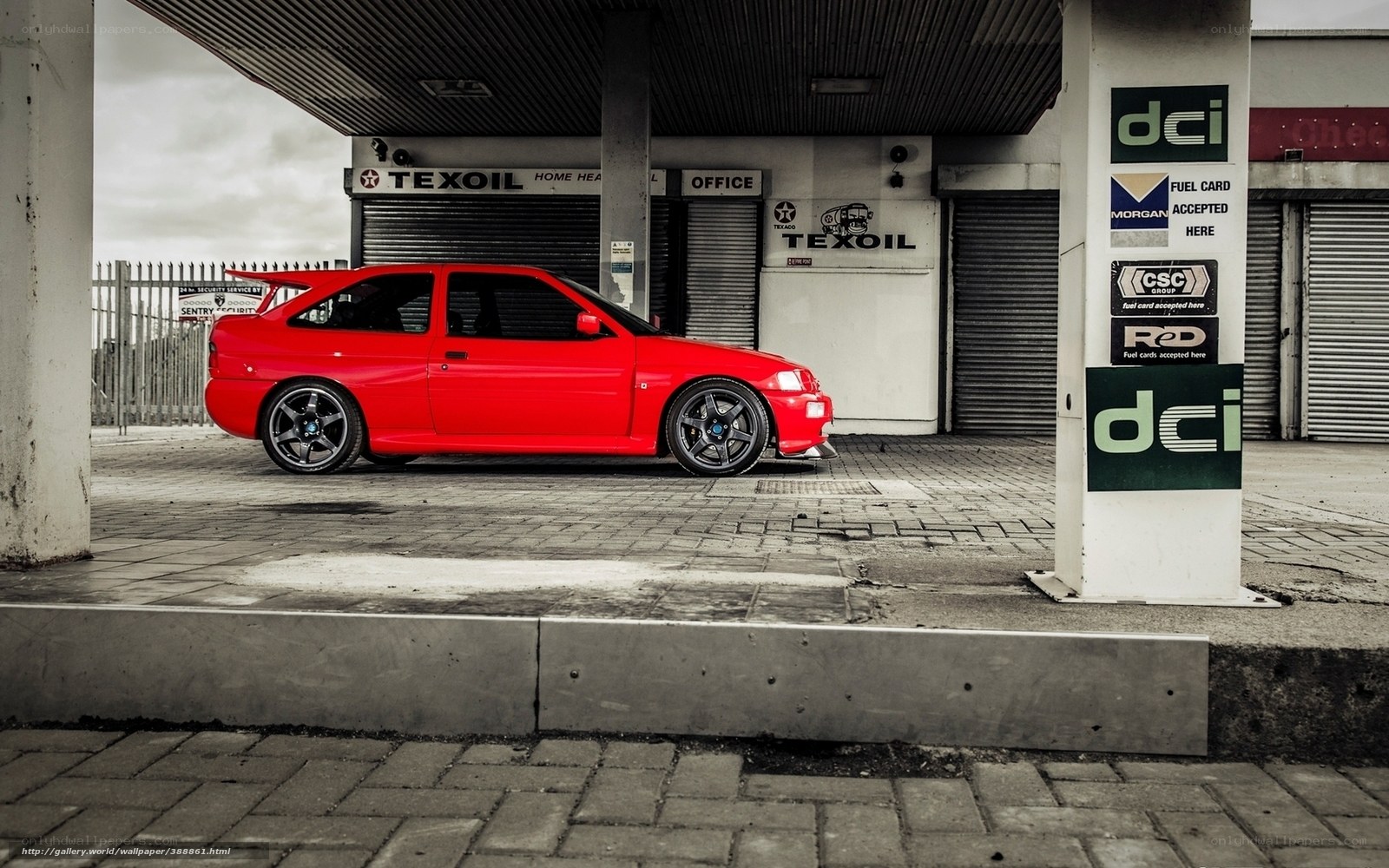 Red car at gas station