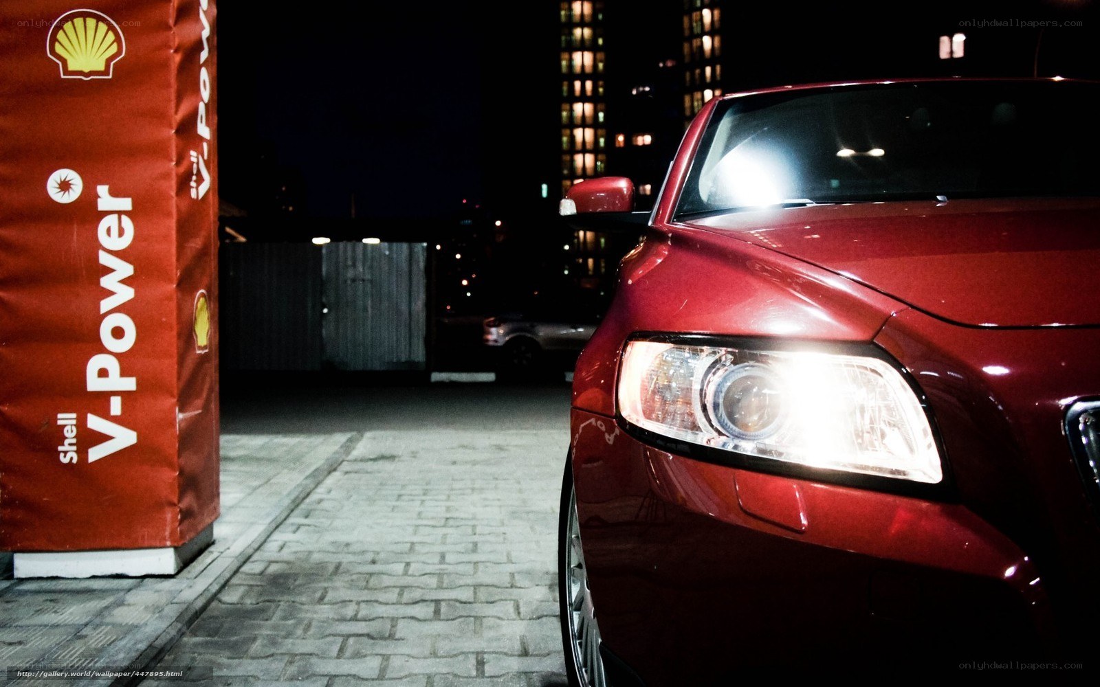 Red car at night gas station