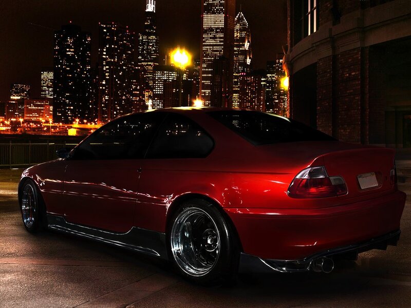 Red car at night in city