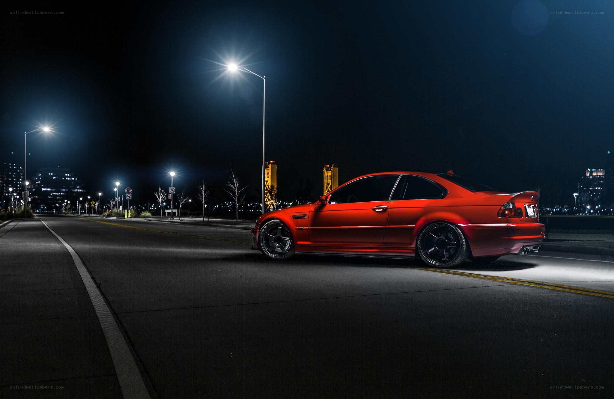 Red car at night on city street