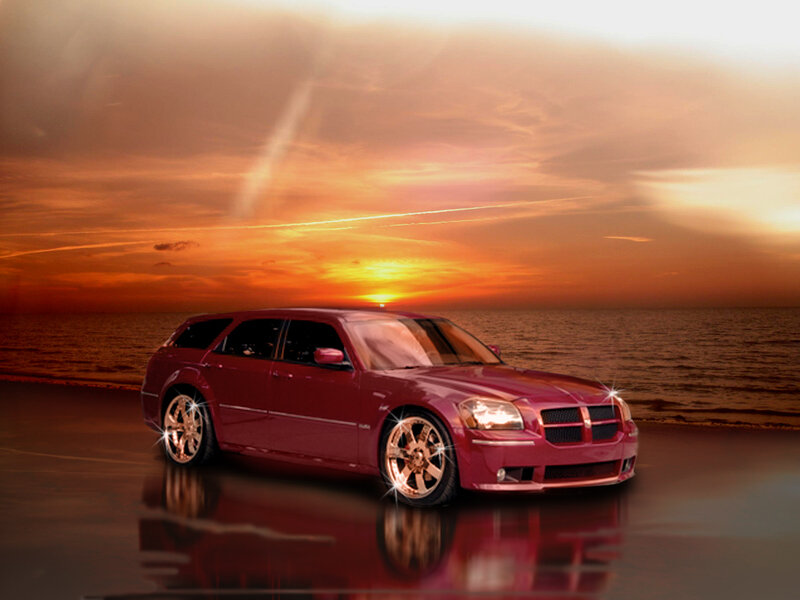 Red car at sunset by the sea