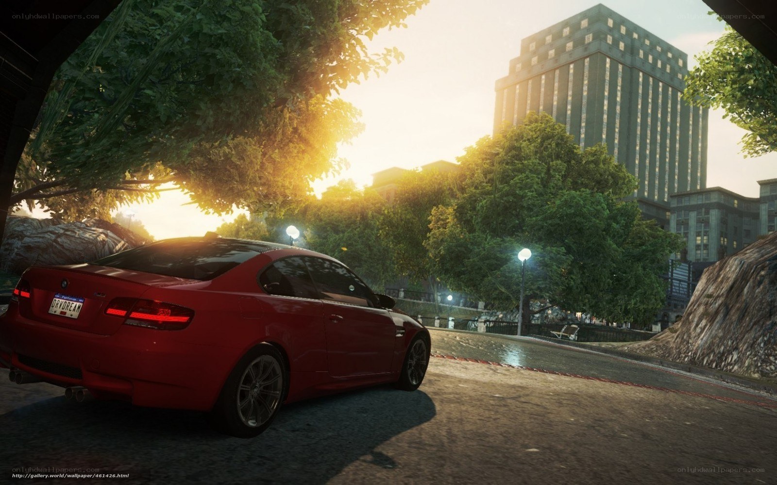 Red car at sunset in city