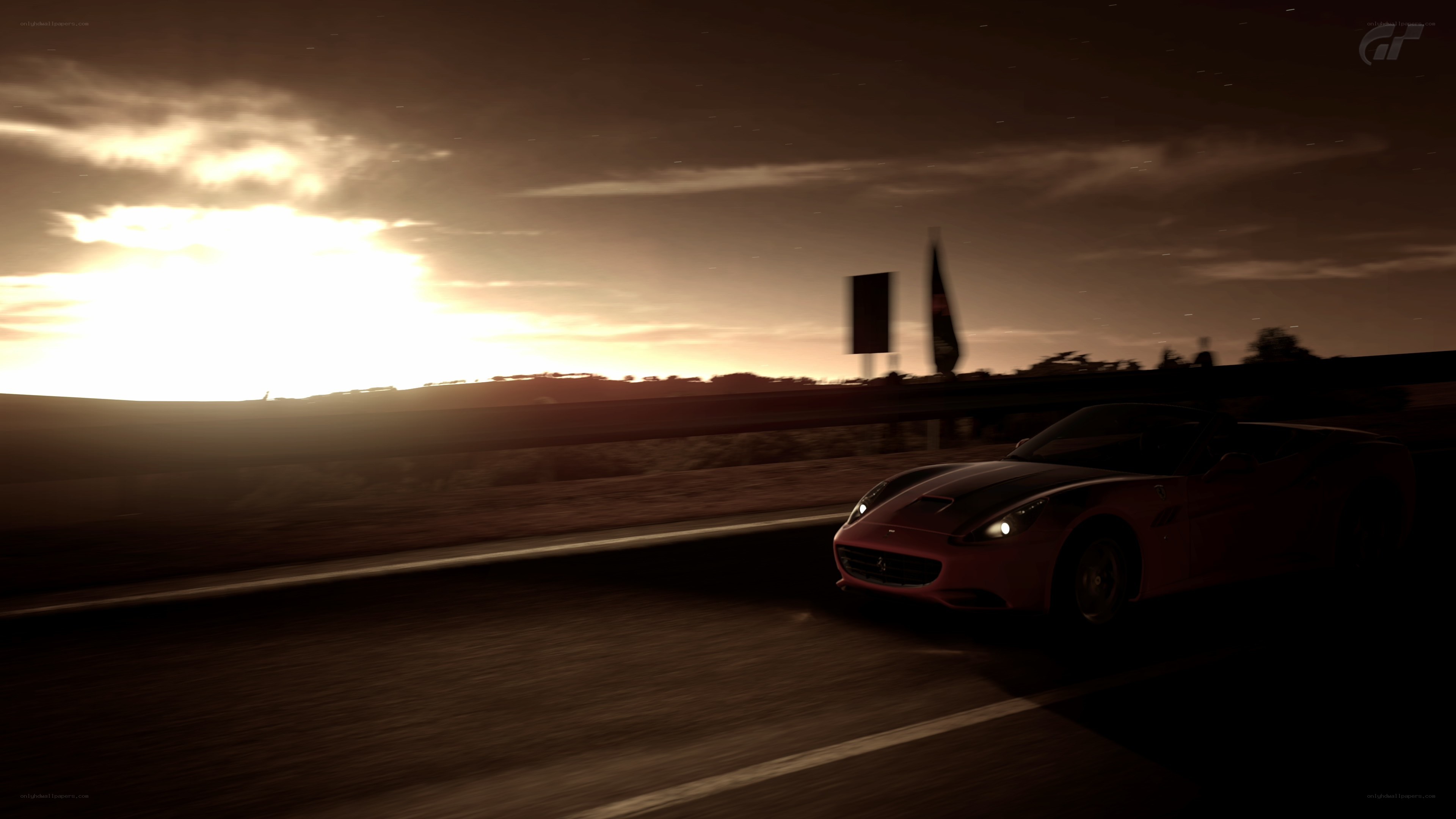 Red car at sunset on road
