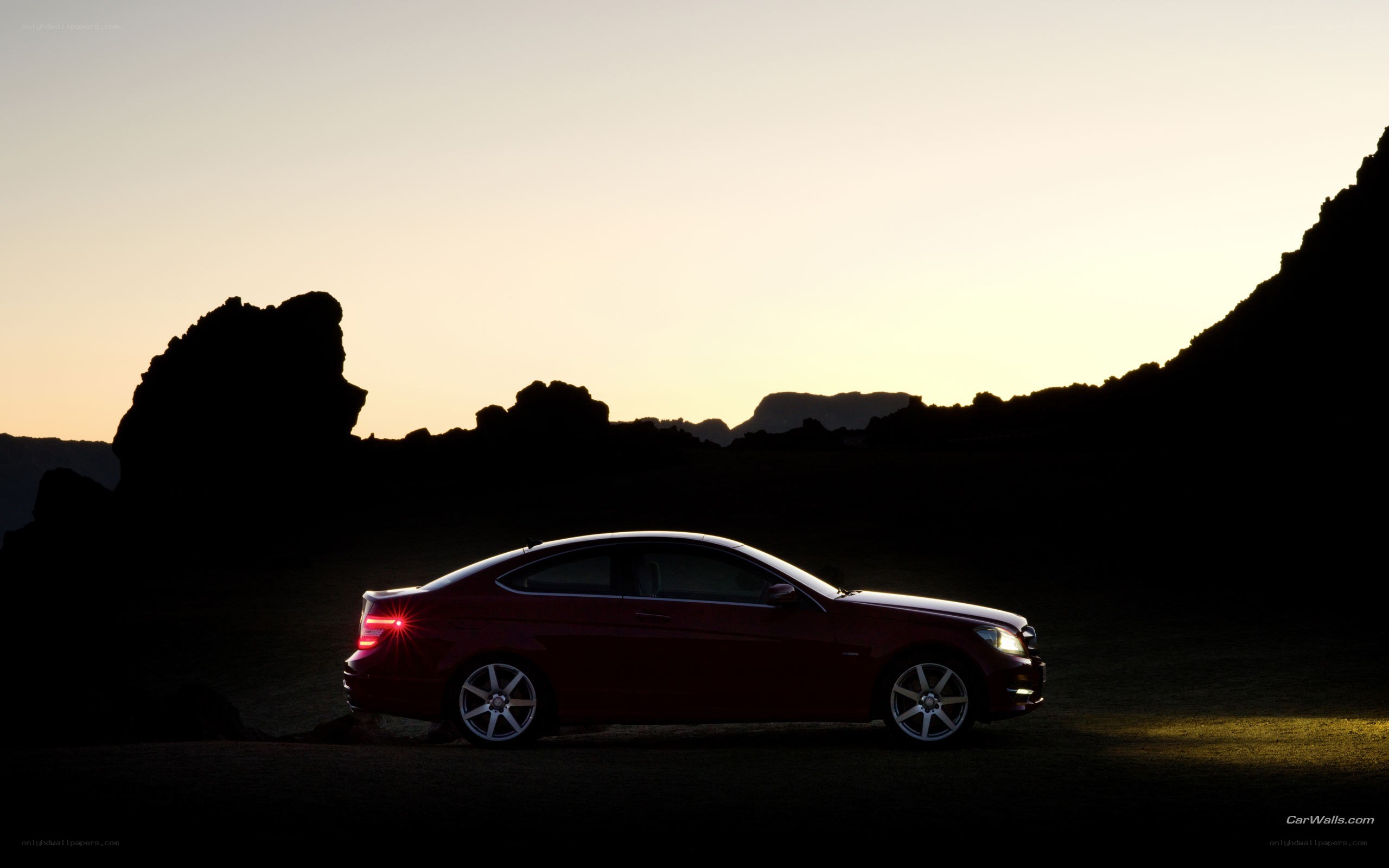 Red car at sunset silhouette