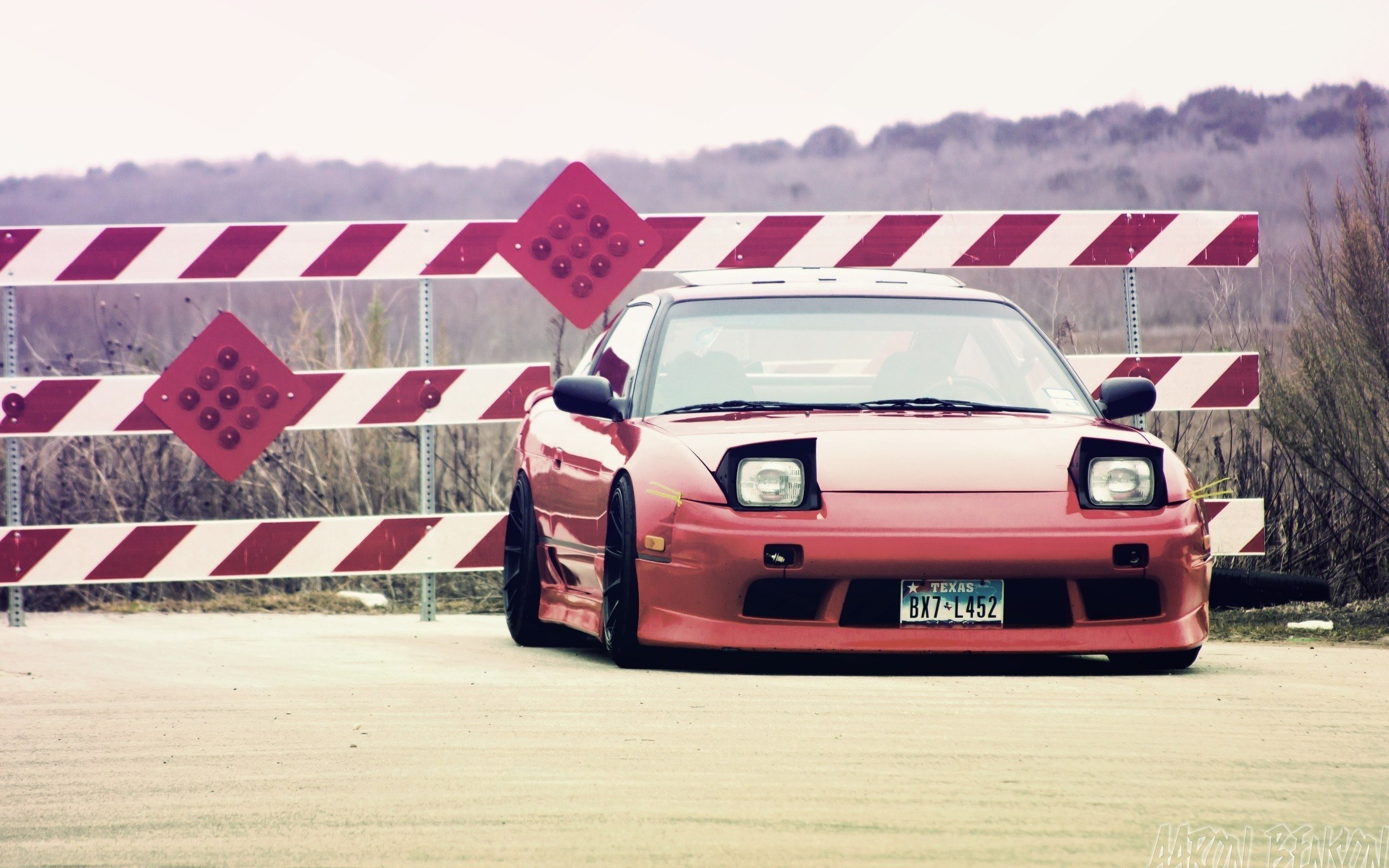 Red car behind barricade