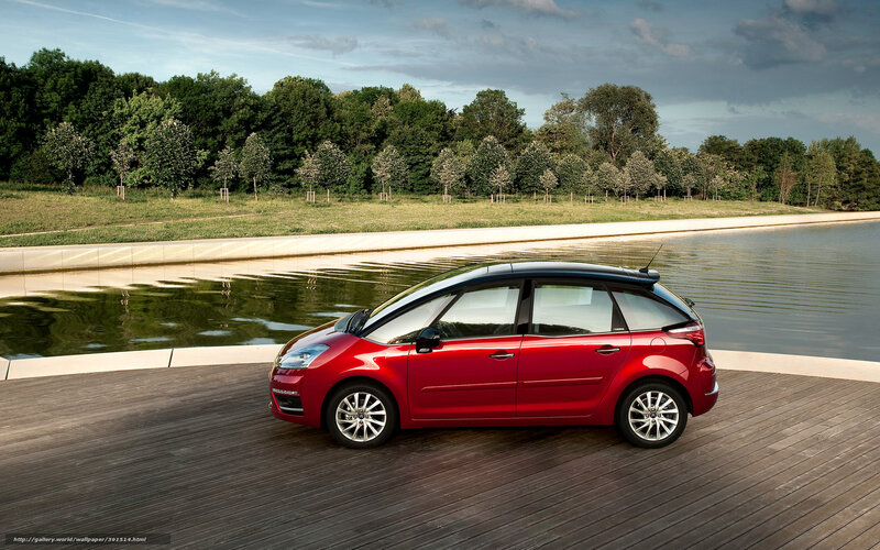 Red car by a lake