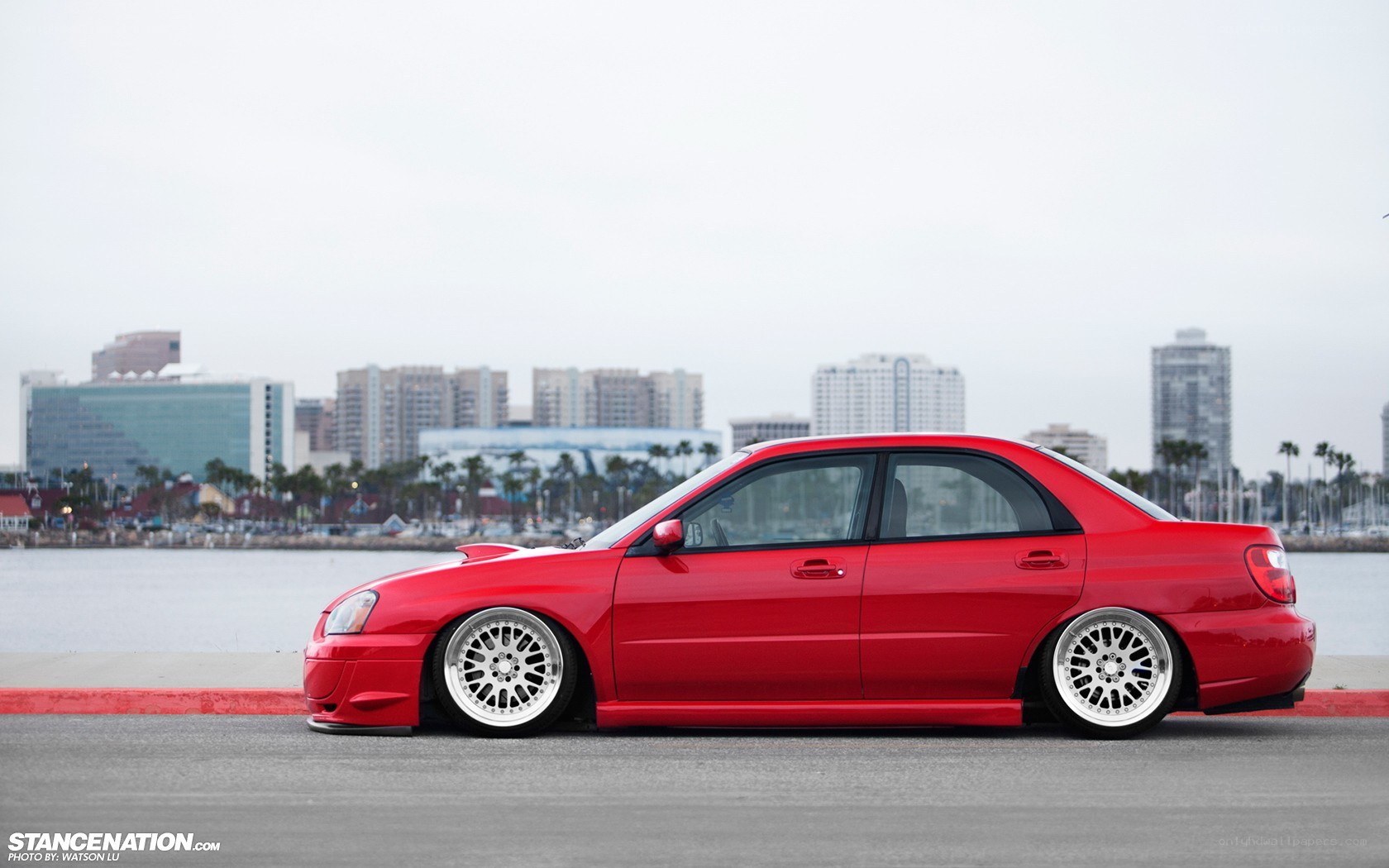 red car by the water