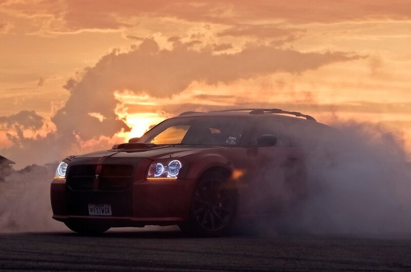 Red car drifting at sunset