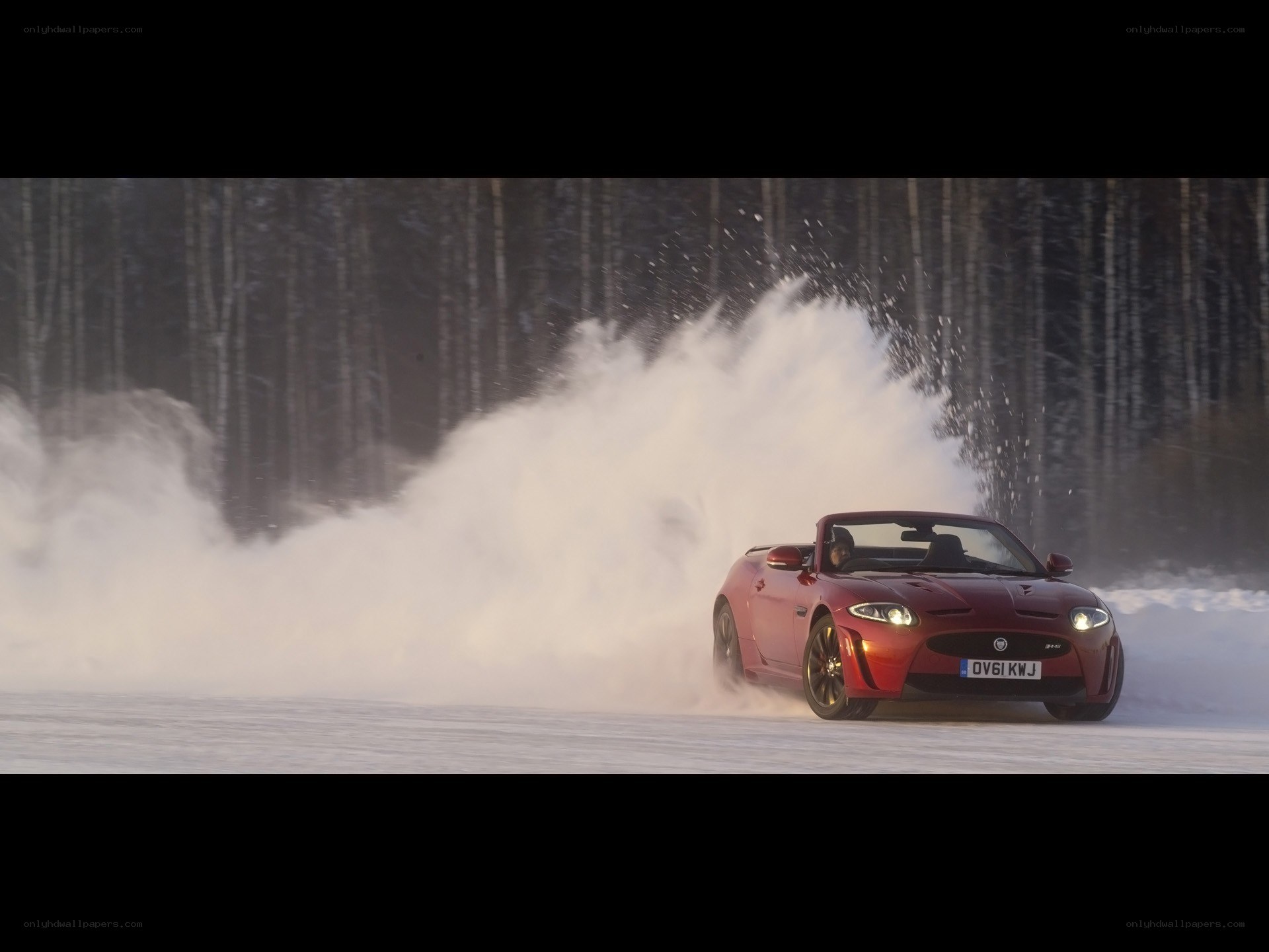 Red car drifting in snow