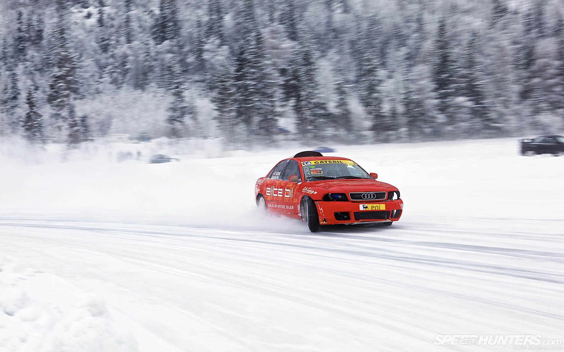 Red car drifting in snow
