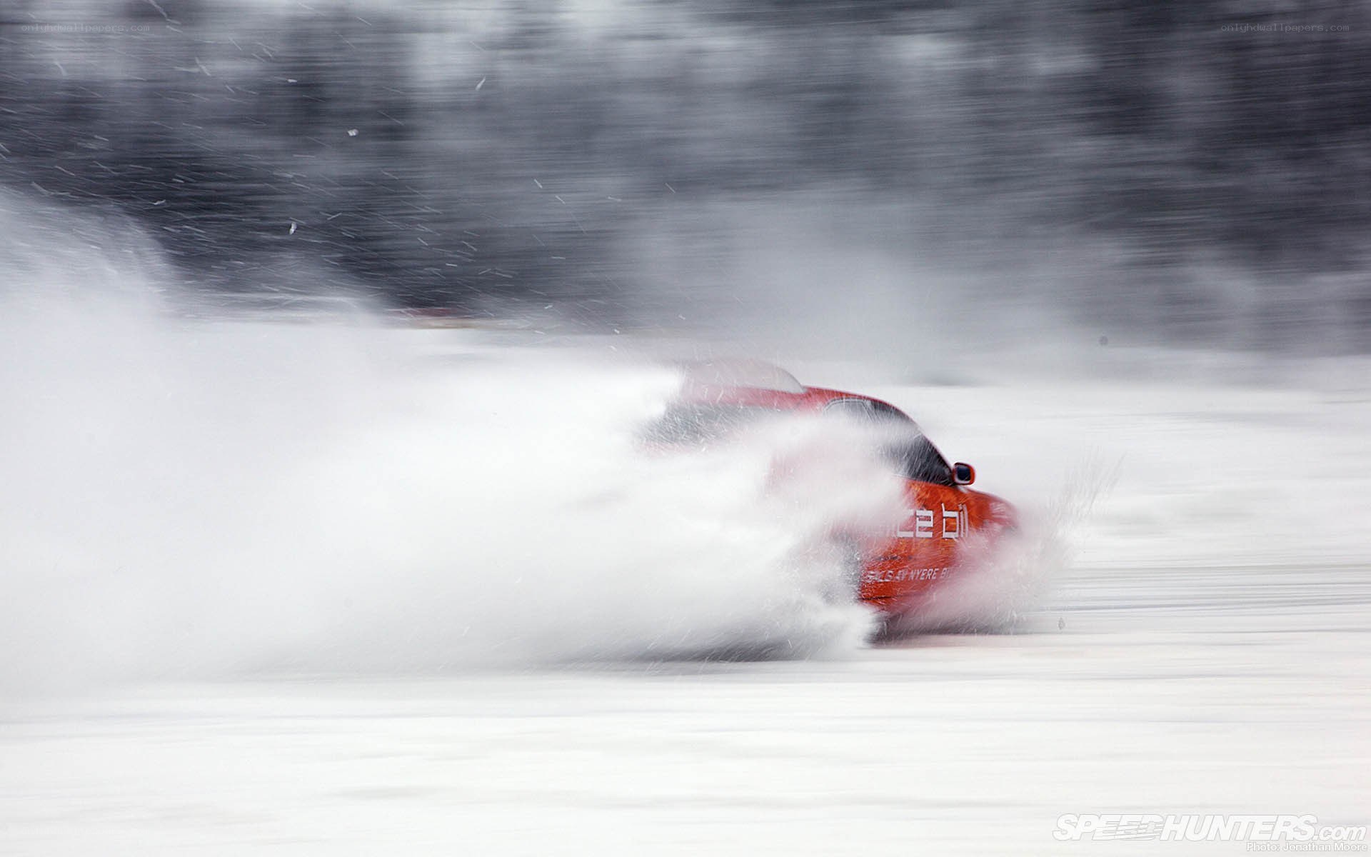 Red car drifting in snow