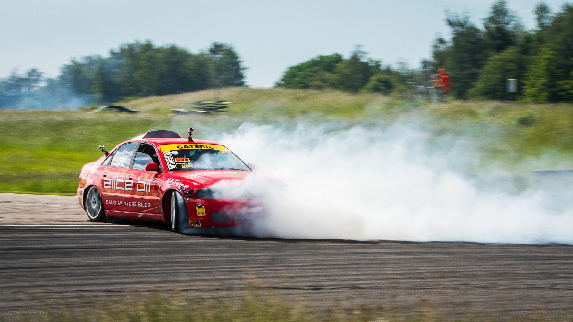 Red car drifting on track