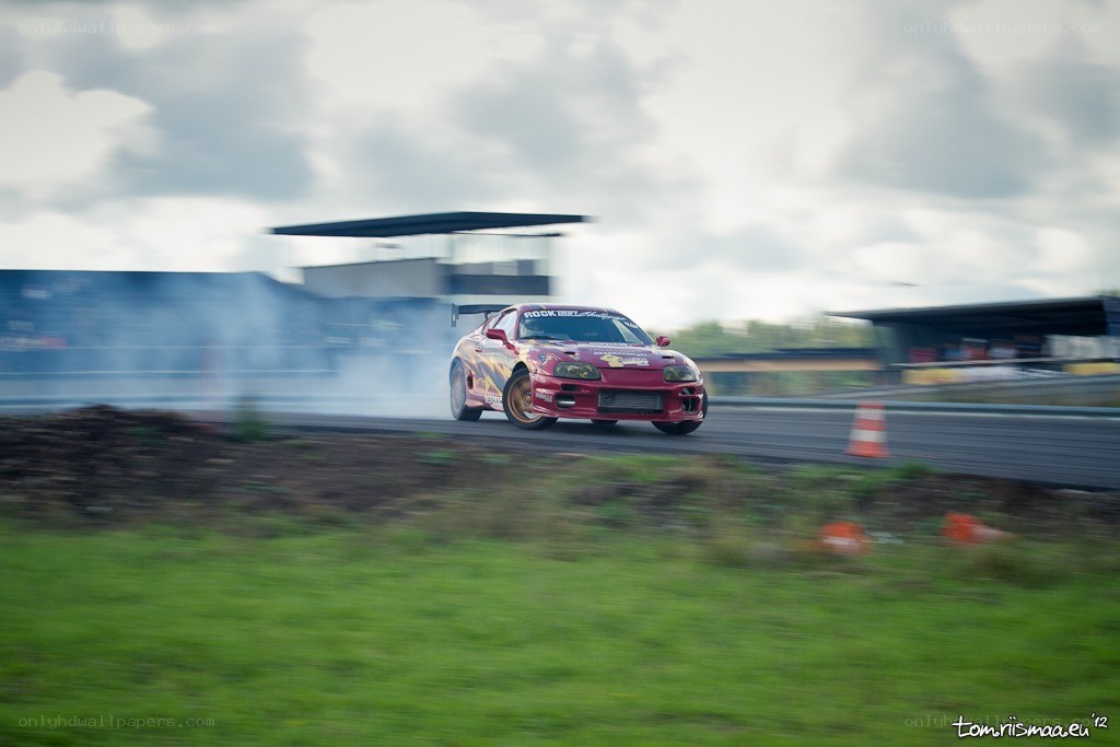 Red car drifting on track
