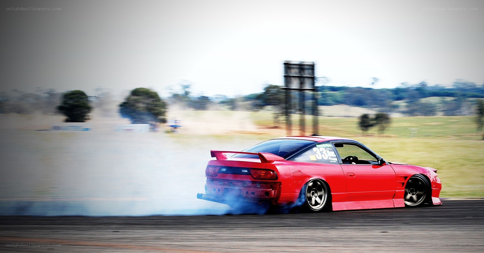 Red car drifting on track