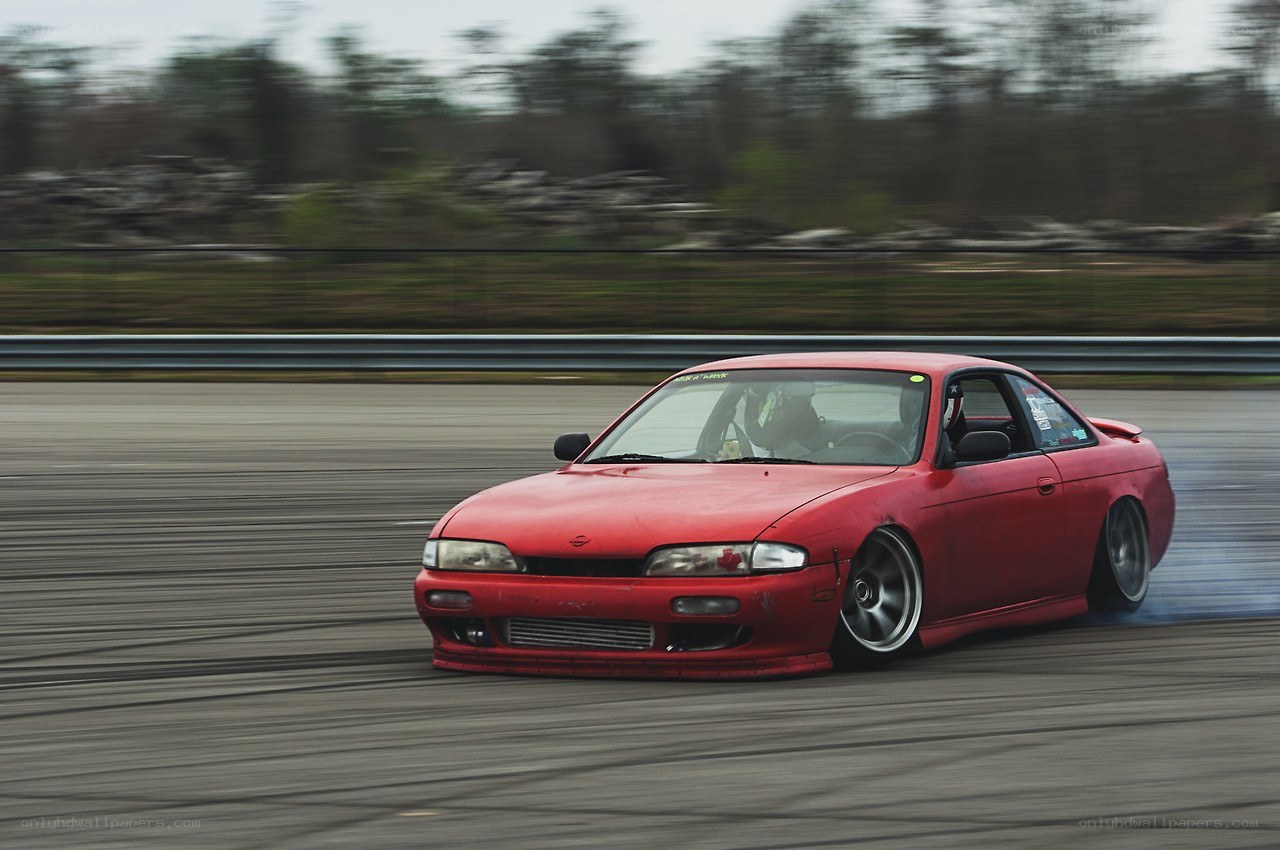 Red car drifting on track