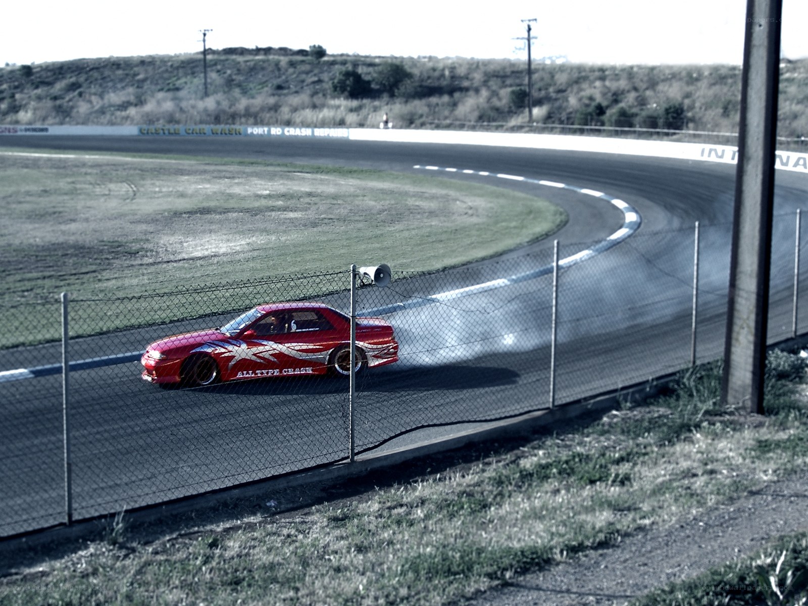 Red car drifting on track
