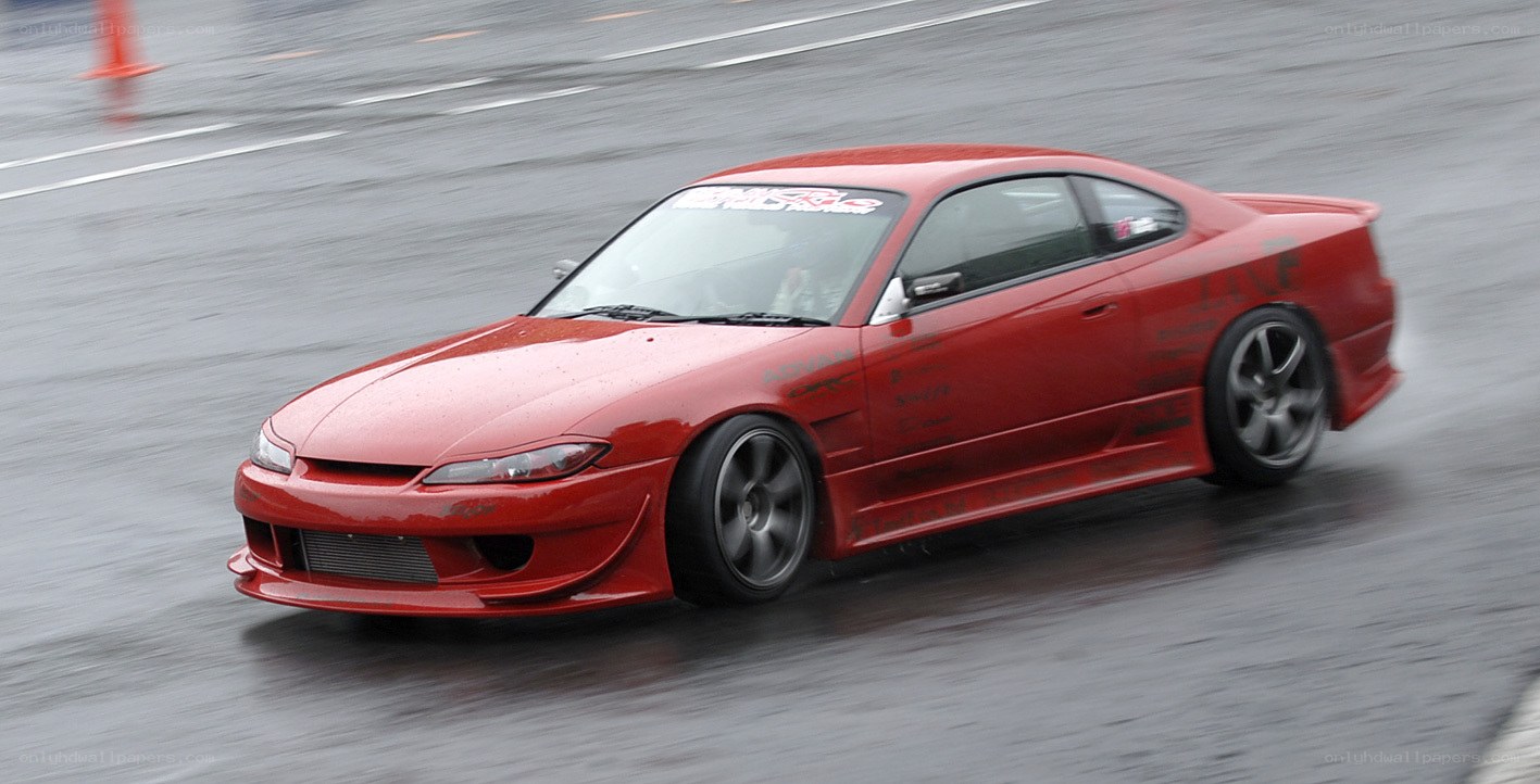 red car drifting on wet track