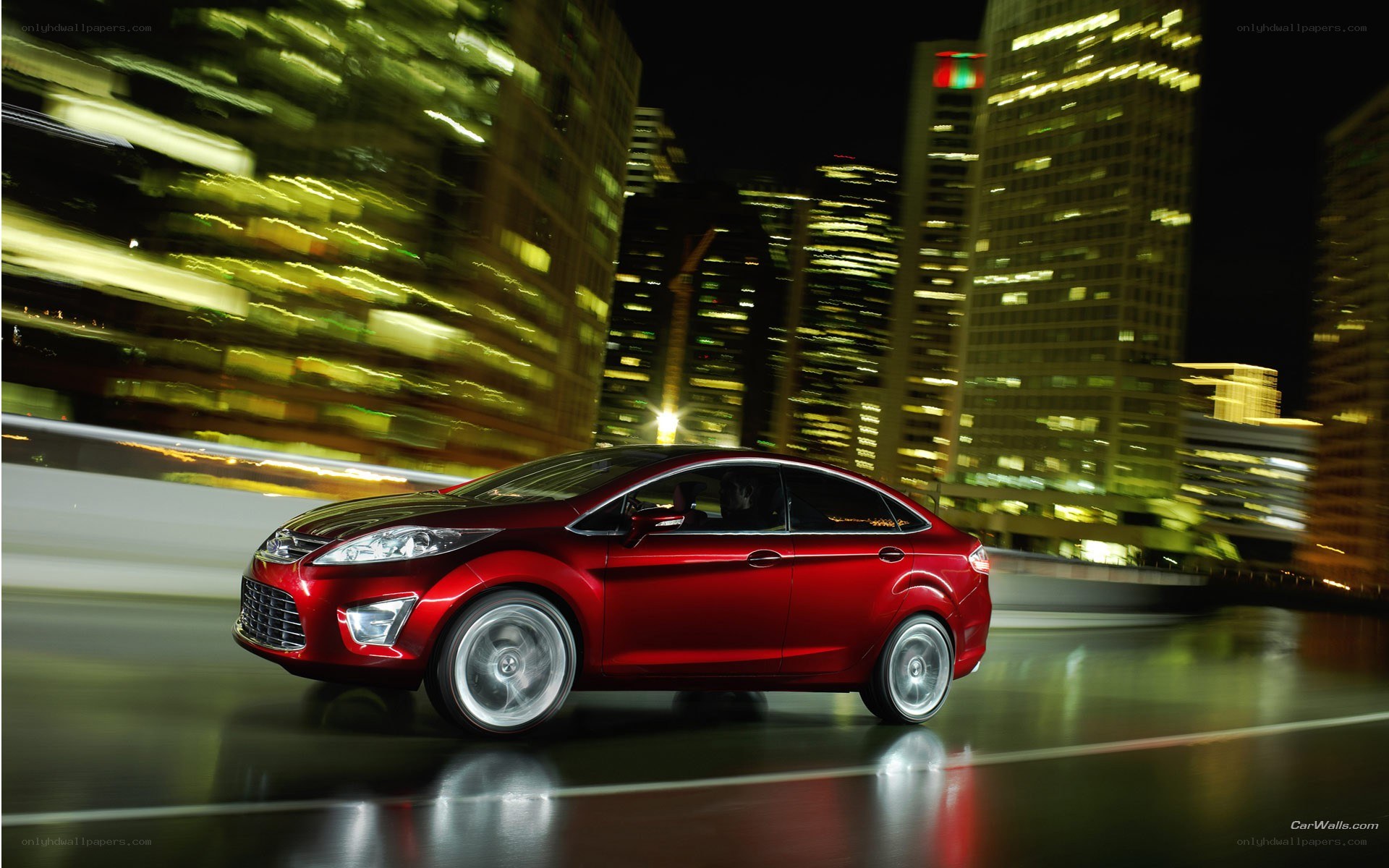 Red car driving at night