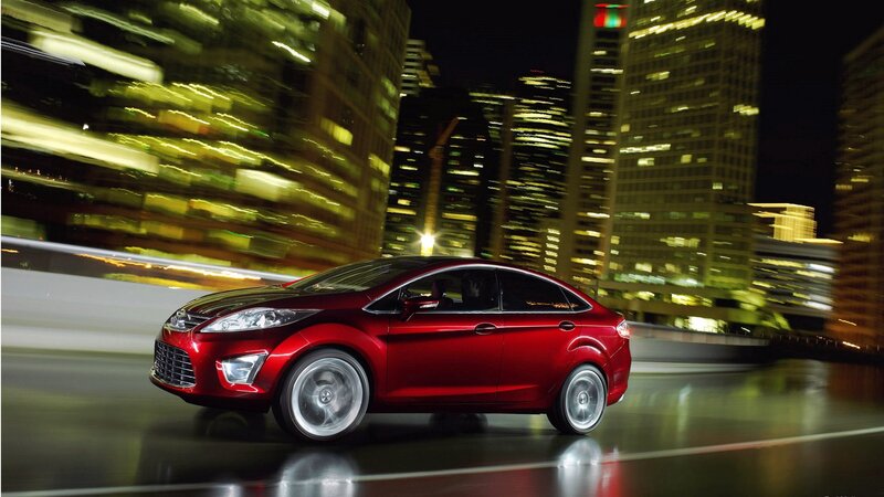 Red car driving at night