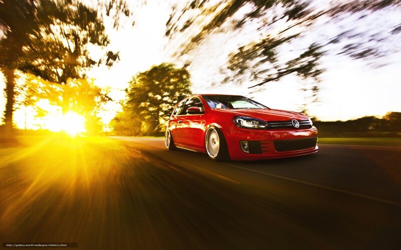 Red car driving at sunset