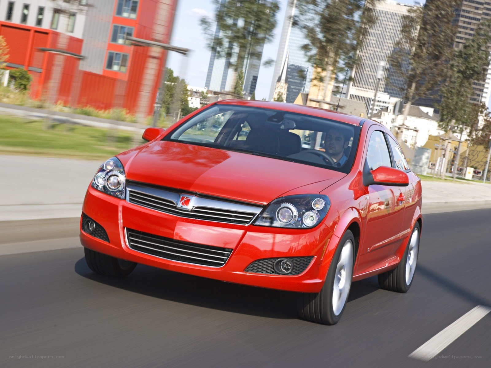 Red car driving in city