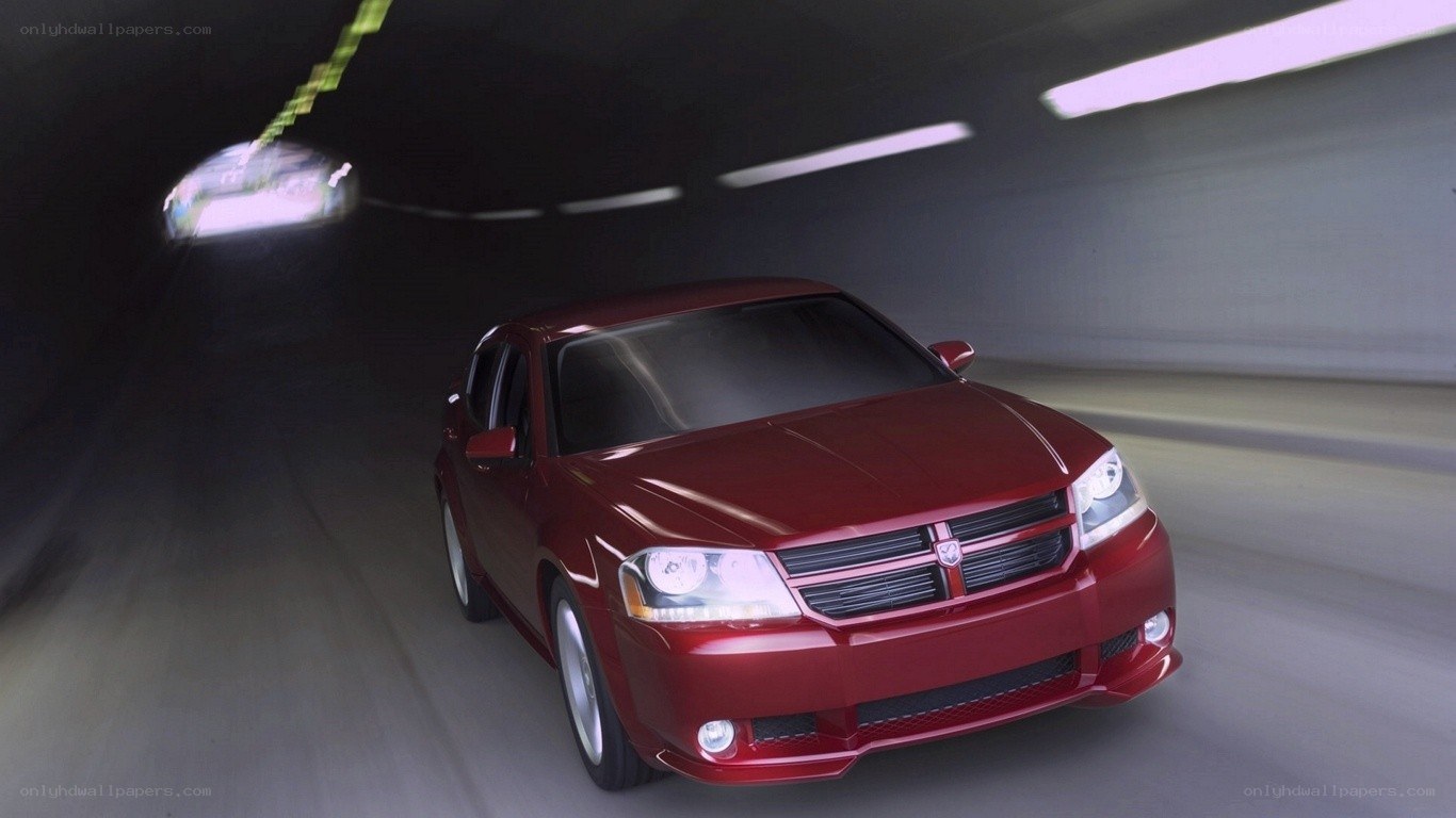 Red car driving in tunnel