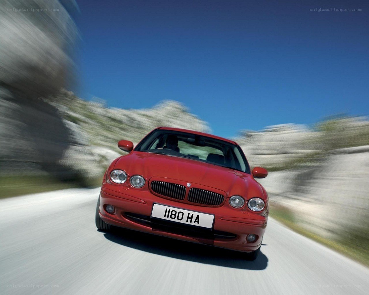 Red car driving on a road