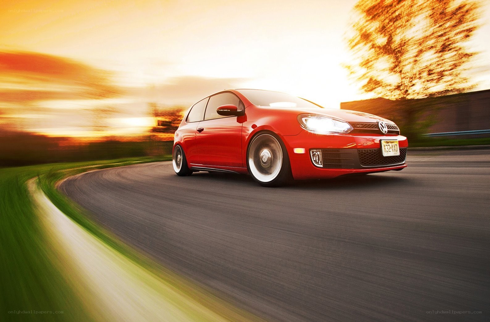 Red car driving on a road