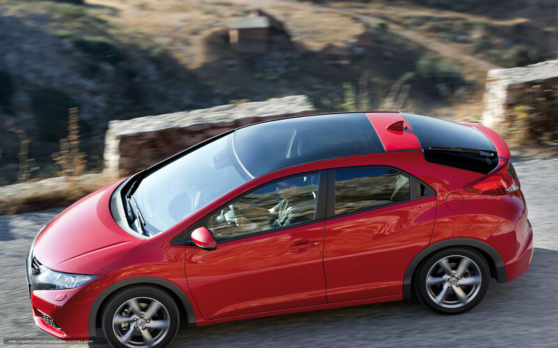 Red car driving on a road