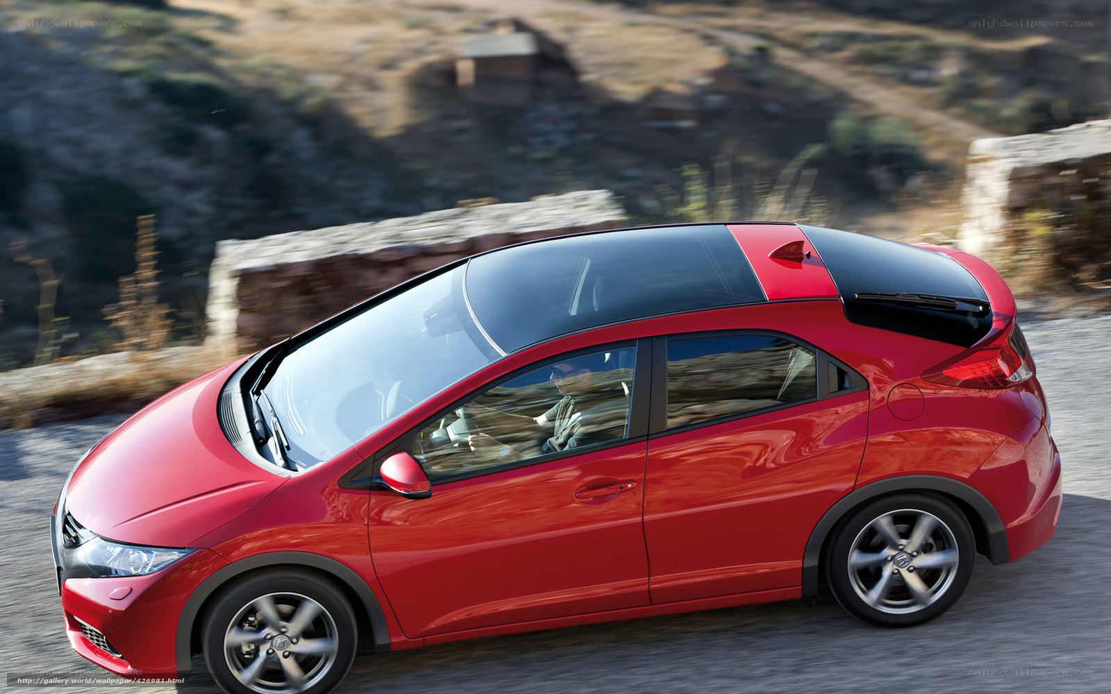 Red car driving on a road
