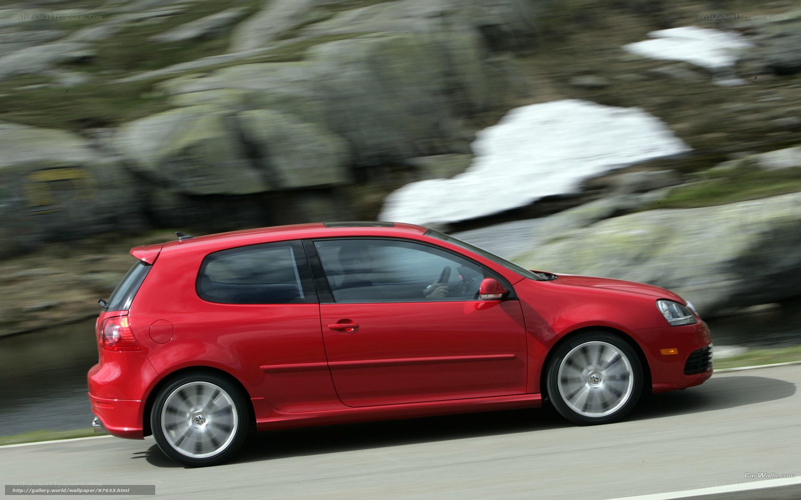 red car driving on mountain road