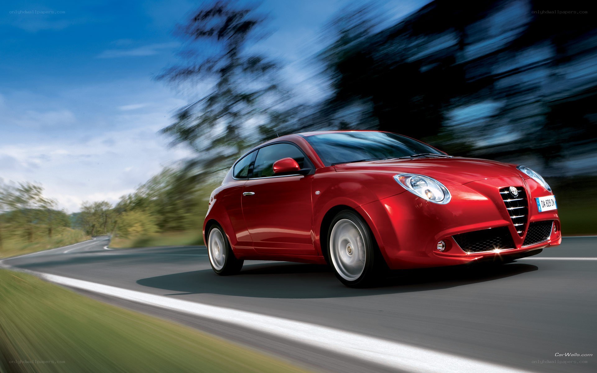 red car driving on road