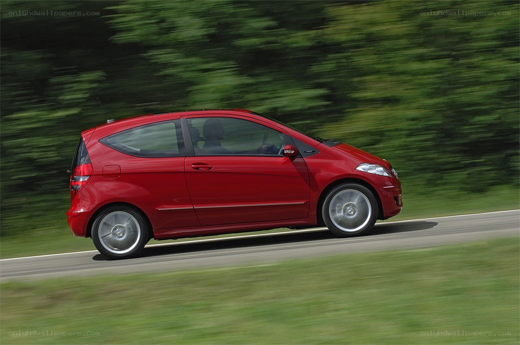 red car driving on road