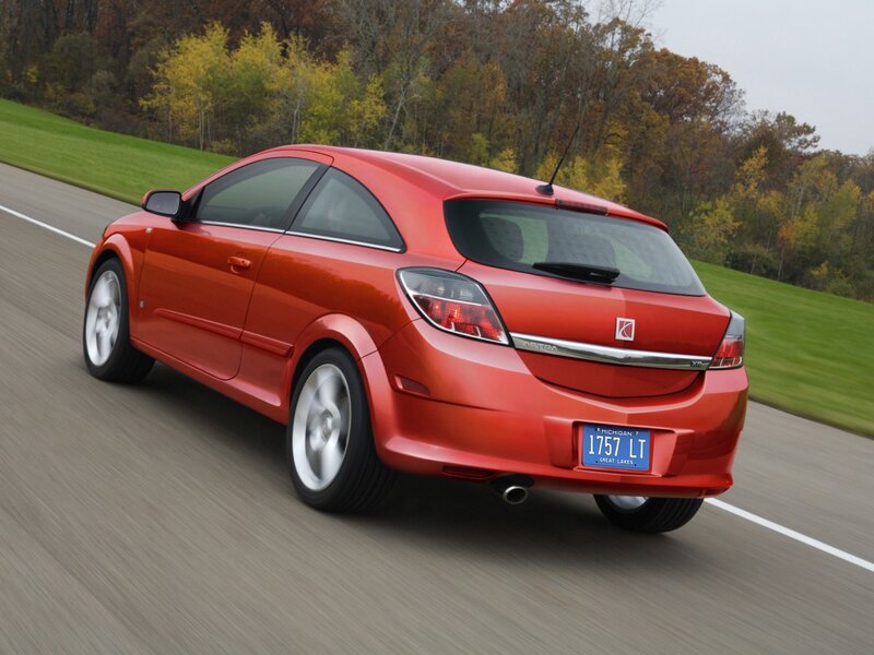 red car driving on road