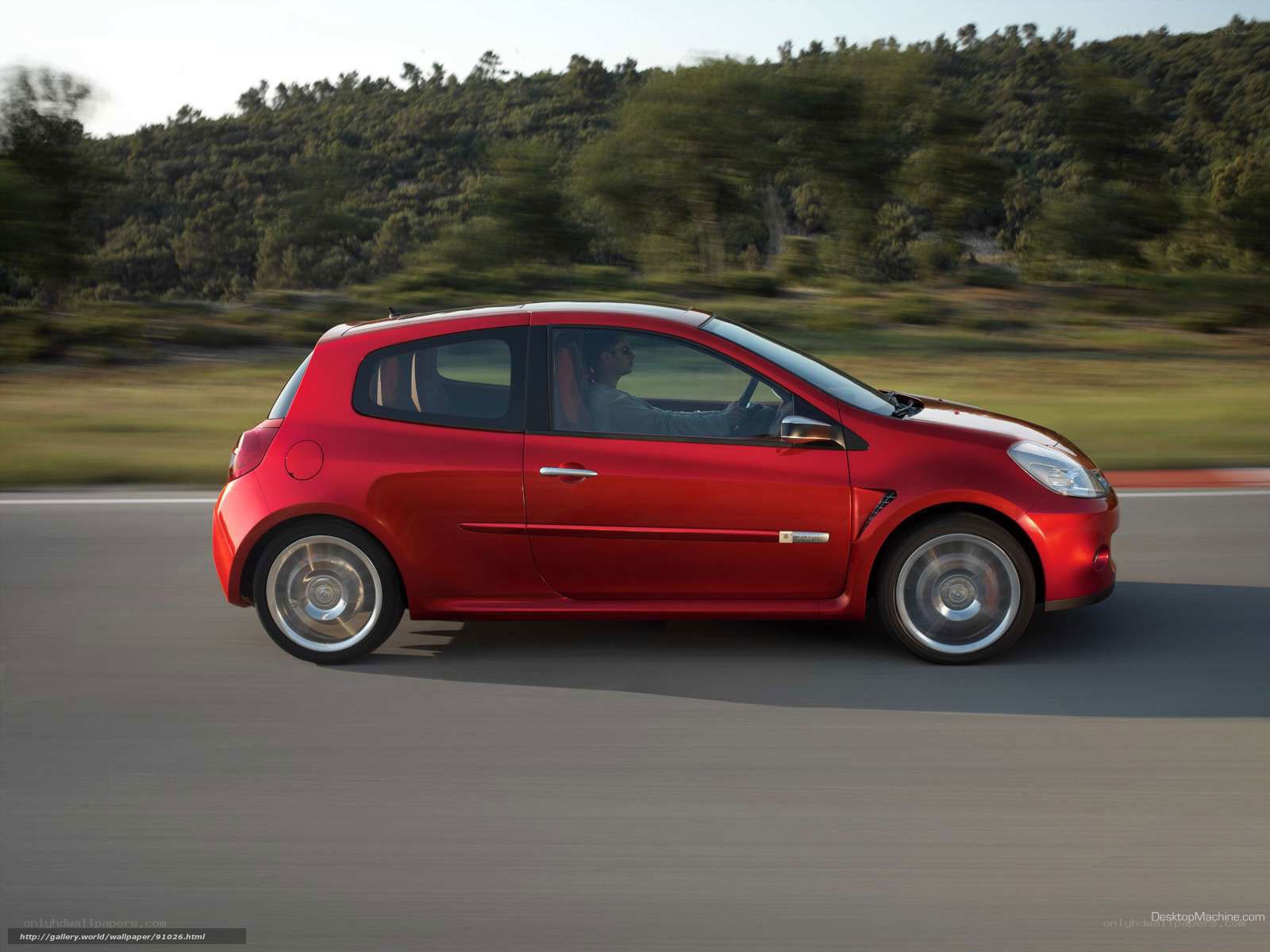 red car driving on road