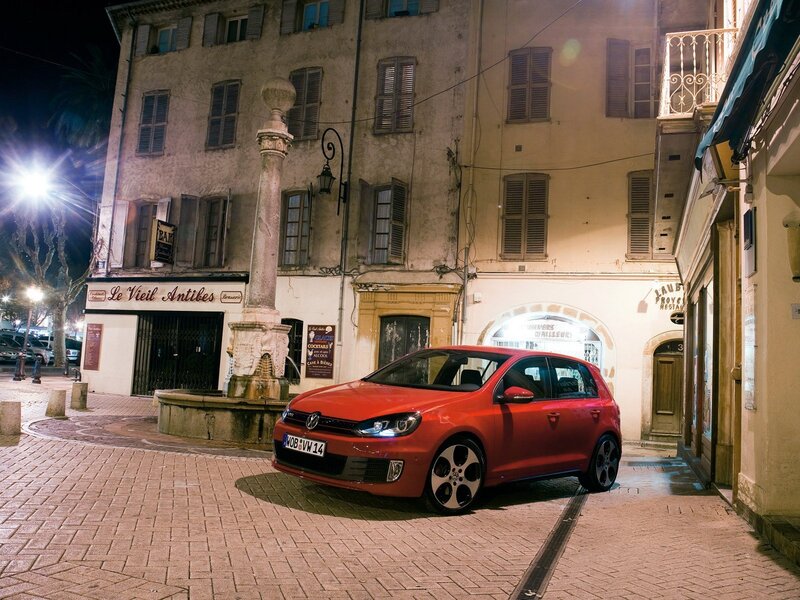 Red car in a European town square