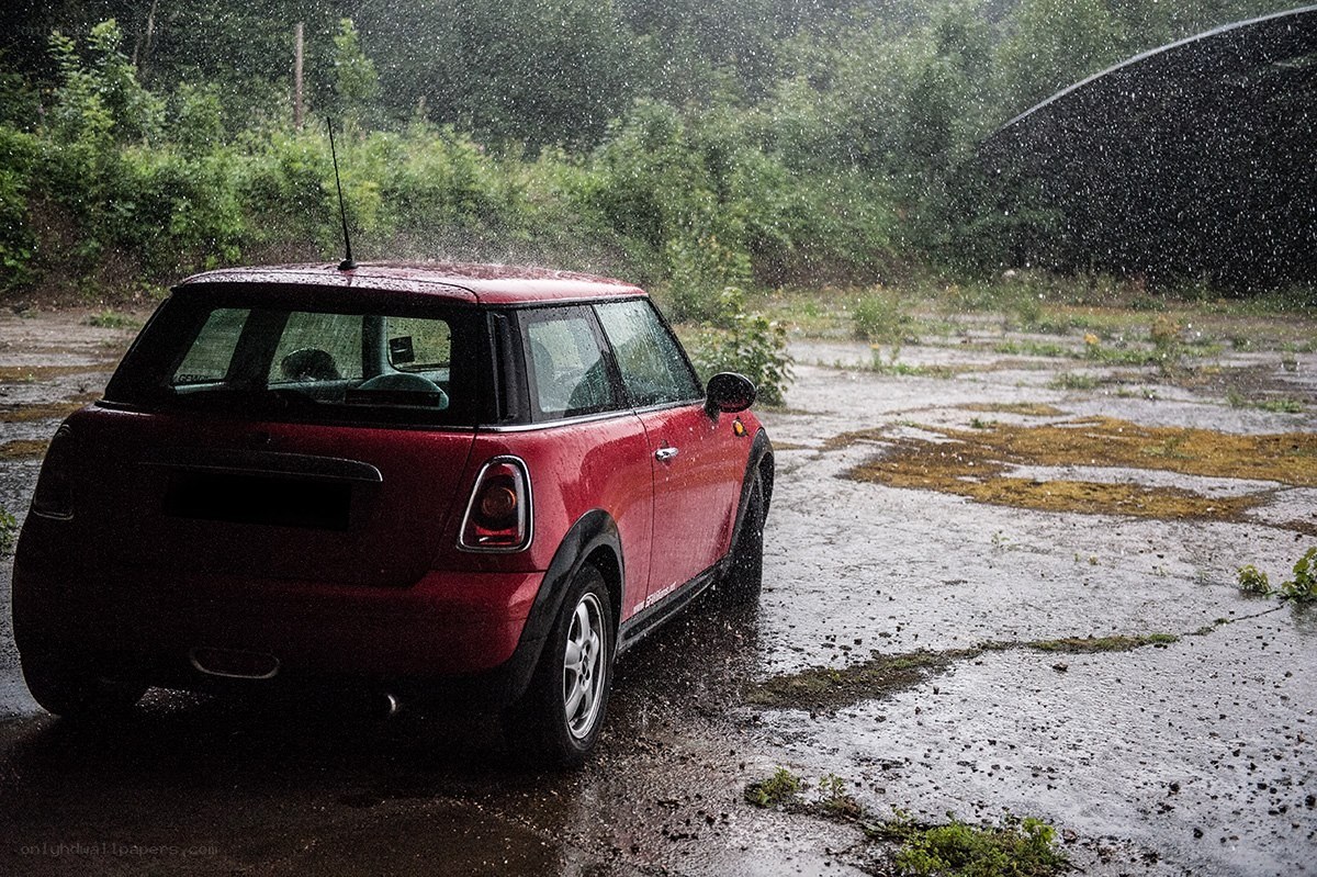 Red car in a rainstorm