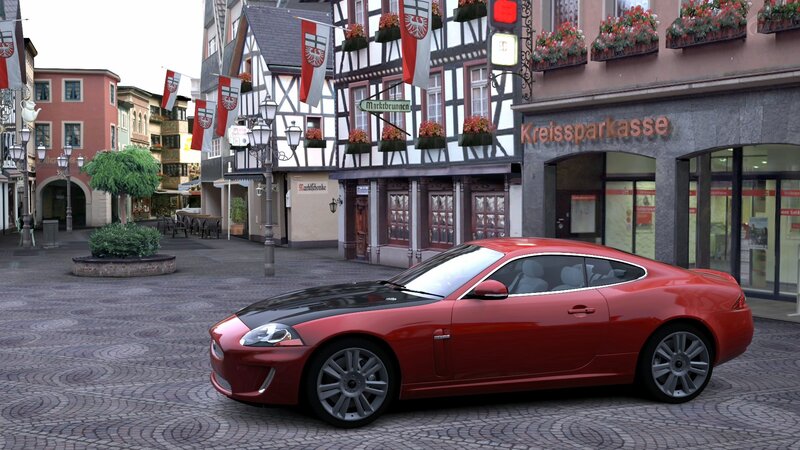 Red car in a town square