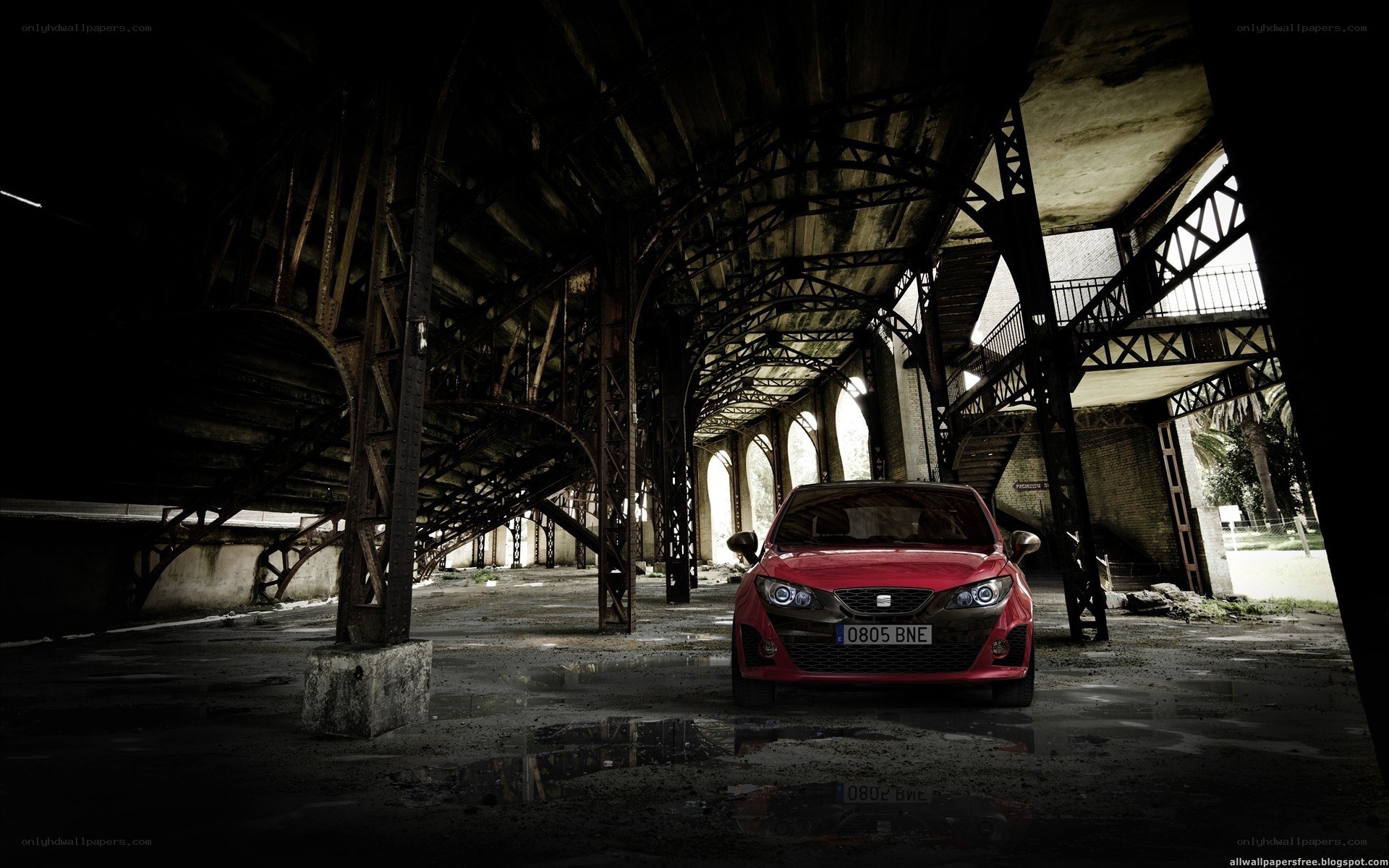 Red car in abandoned warehouse