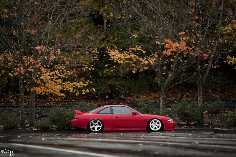 Red car in autumn parking lot