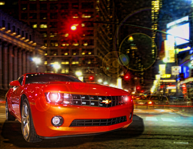 Red car in city at night