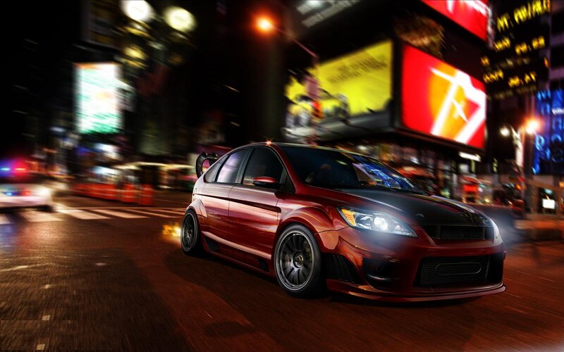 Red car in city at night